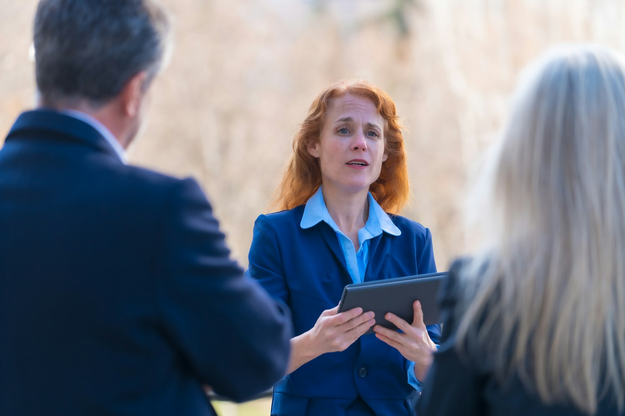 Collaborative and Innovative Red-Haired Female Business Professional Engaging in Teamwork